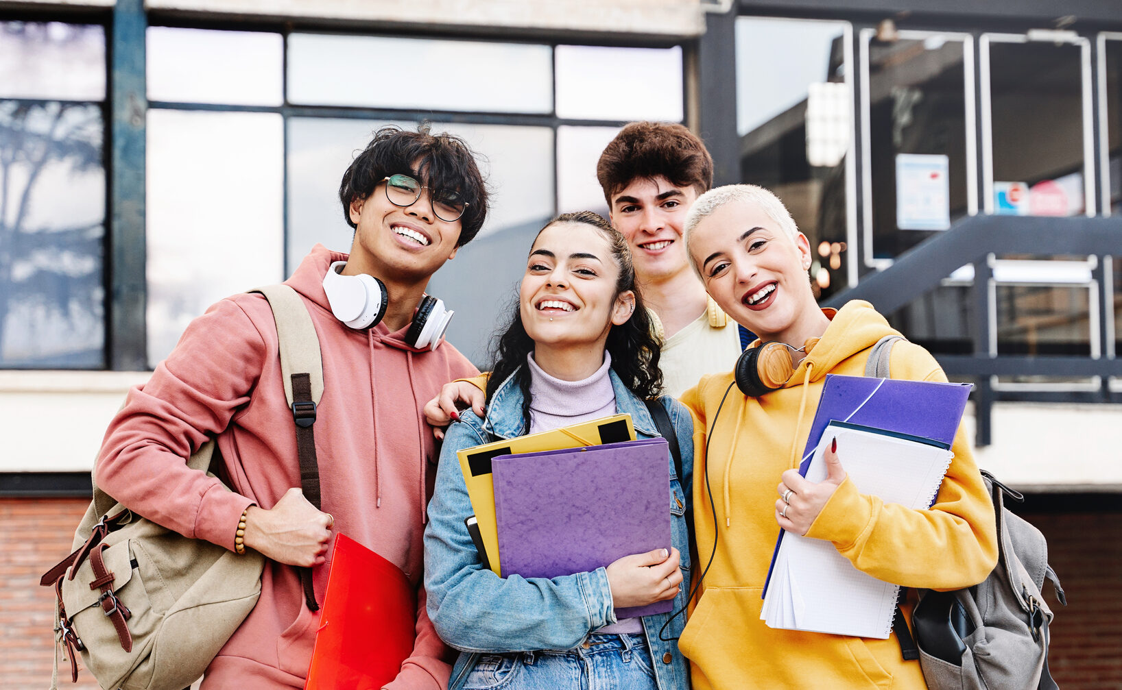 teenagers standing outside school, smiling